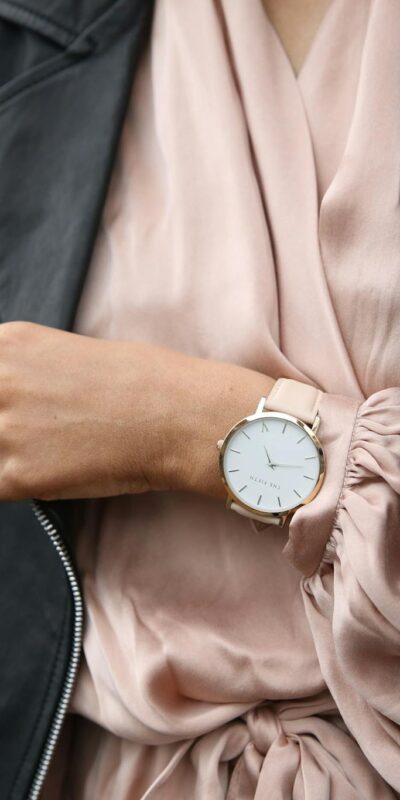Stylish woman in a leather jacket showcasing an elegant wristwatch, perfect for fashion-forward individuals.